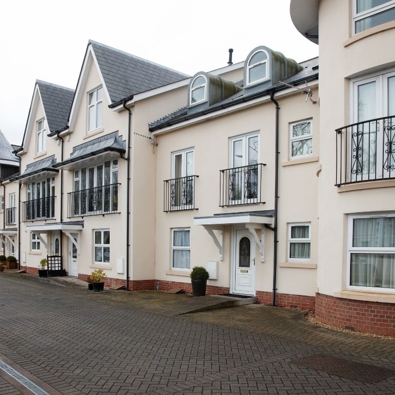 Monocouche through-colour render being ruled off and scraped to finish