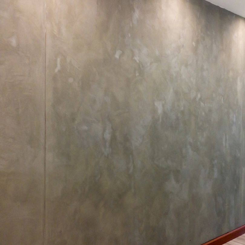 Skim coating a lounge wall to a glass flat finish